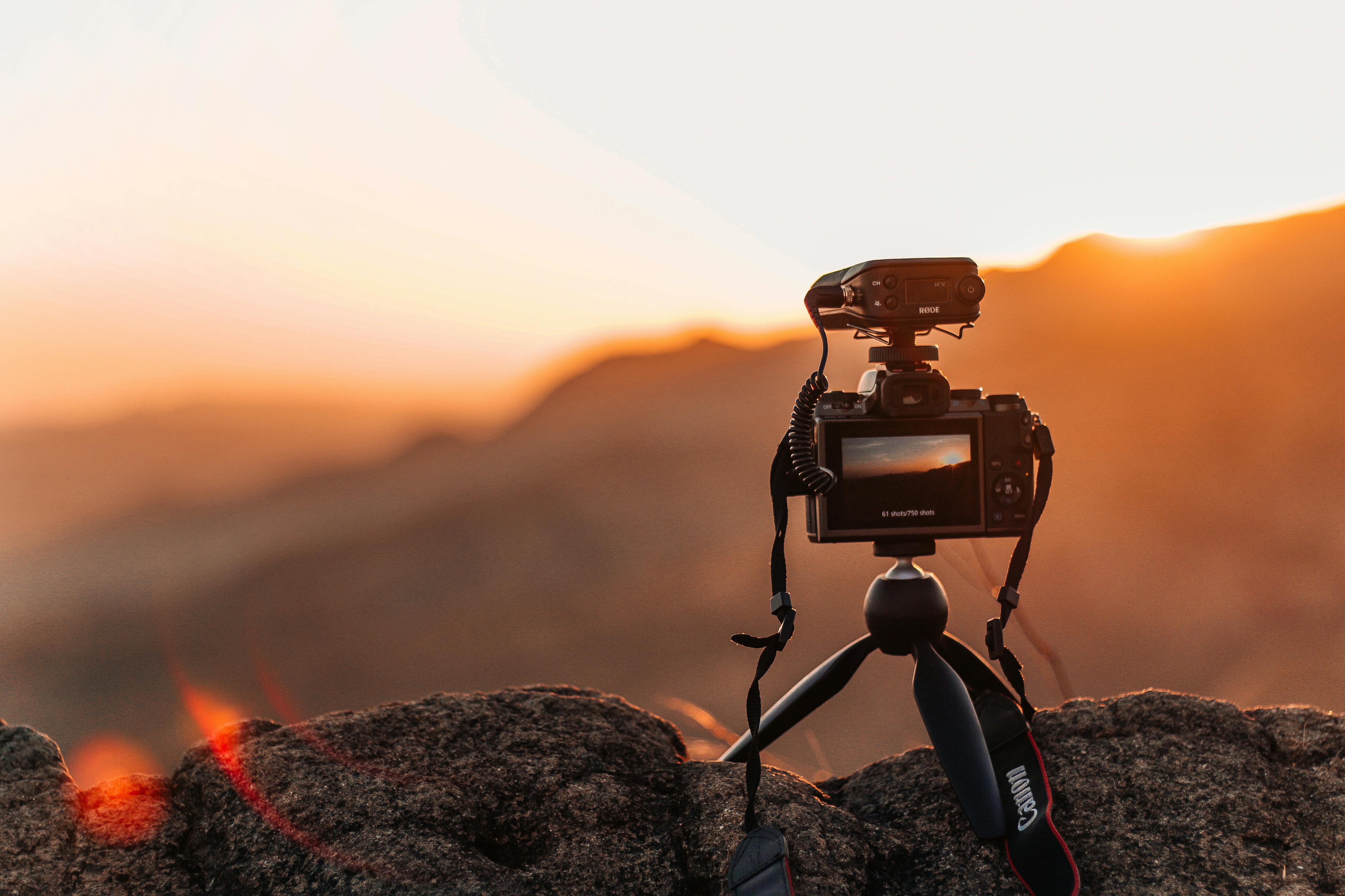 Camera capturing sunset over mountains